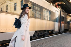 Beautiful girl tourist rushes to the train.